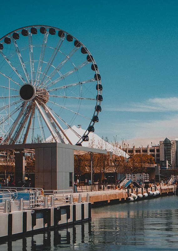 Chicago's Navy Pier alongside the lakeshore with the Centennial Wheel rising over the buildings.