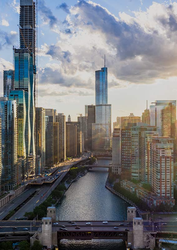 A view of tall city skyscrapers on either side of a river.