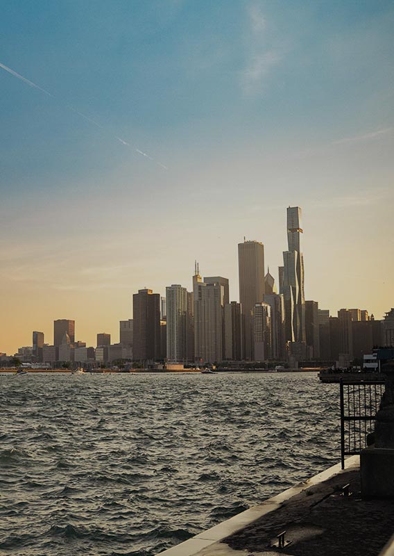 A view across a harbor towards a city of skyscrapers